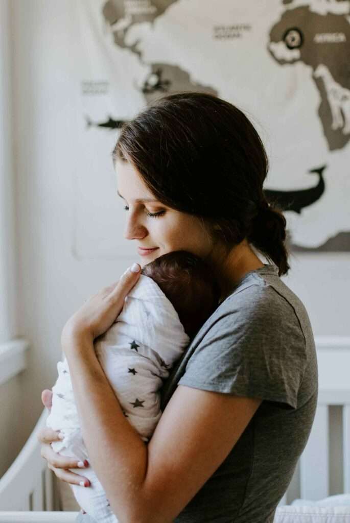 mother holding baby