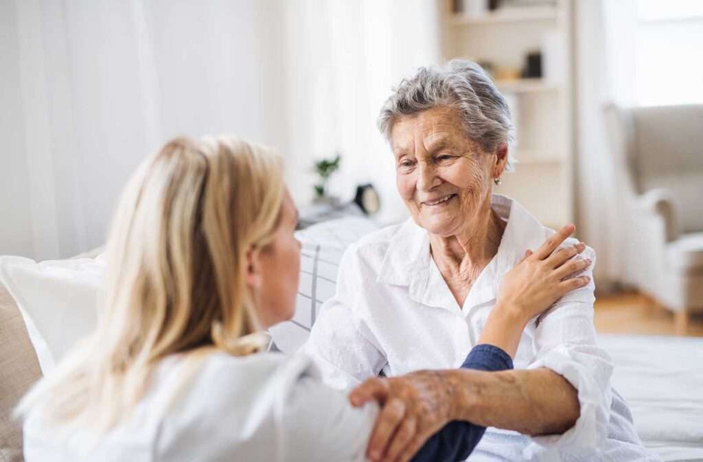 nurse touching old lady on shoulder