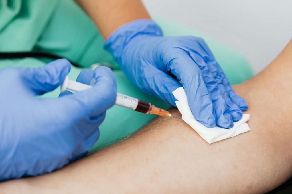 medical worker taking blood sample from patient