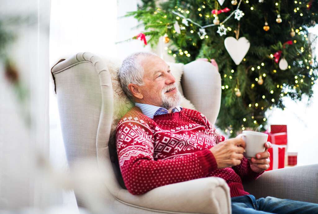 senior man sitting on armchair at home